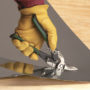 Person cutting a square piece of sheet metal with Malco's AV7 Offset Aviation Snip