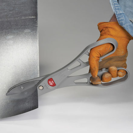 Person with gloves cutting a piece of sheet metal with a Malco 14" MC14N Andy Snip