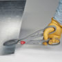 Worker with gloves cutting a piece of sheet metal with Malco's 14