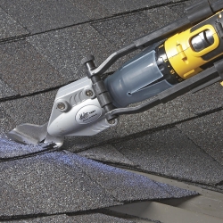 Asphalt shingles on a roof being cut with a Malco TSS1